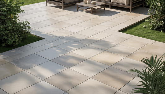 A modern patio with porcelain tiles in a geometric pattern, surrounded by plants and featuring a cozy seating area.