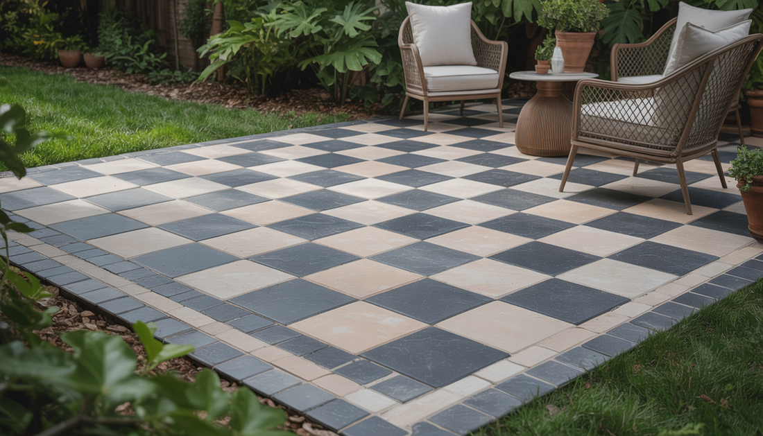 A backyard with a checkerboard paver patio, surrounded by greenery and outdoor furniture, creating a cozy setting.